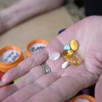 A woman holds some prescription drugs.